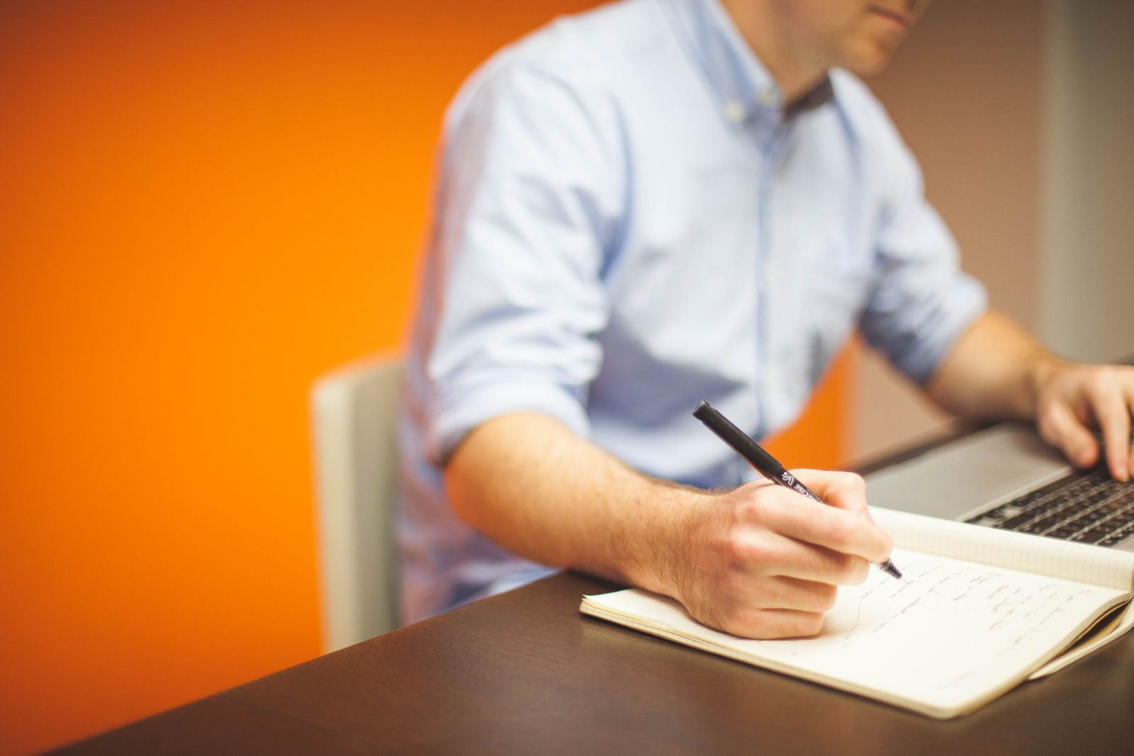 A notebook checklist beside a laptop, planning a Western Sydney business website